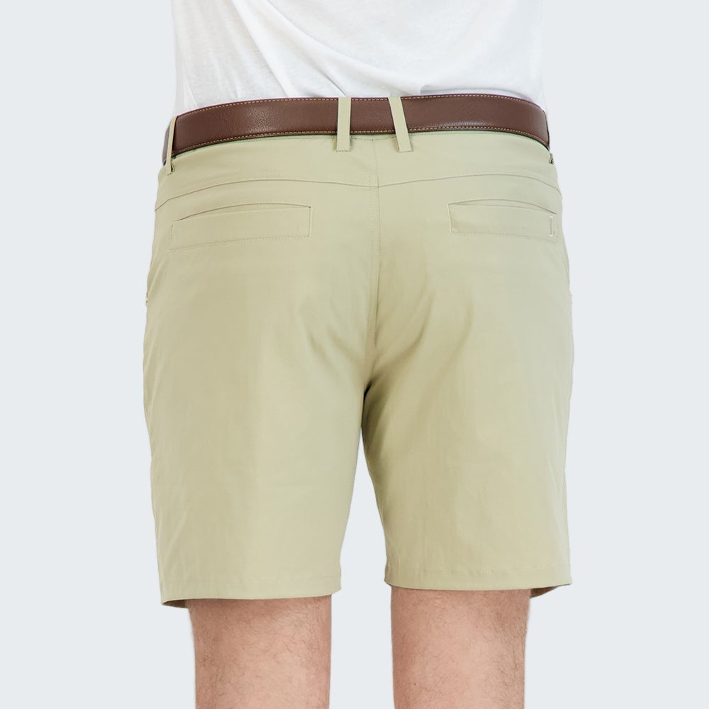 Beige shorts worn by a person on a white background