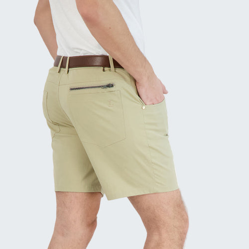 Beige shorts worn by a person on a white background