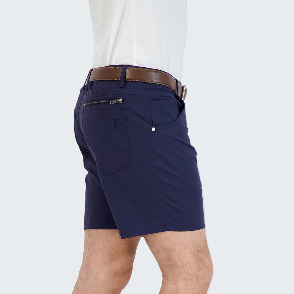Person wearing navy shorts with a white background