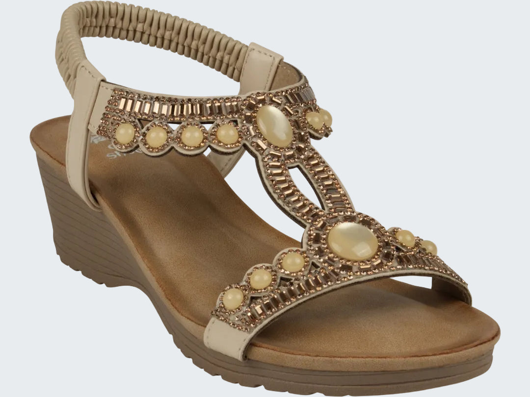 Beige sandal with decorative elements on a white background
