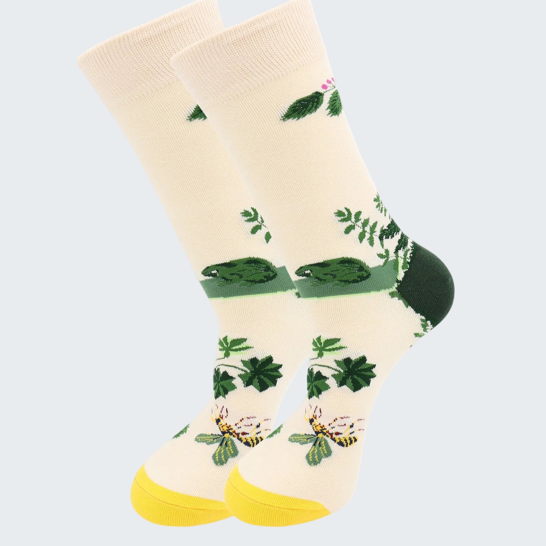 Beige socks with green leaf patterns on a white background