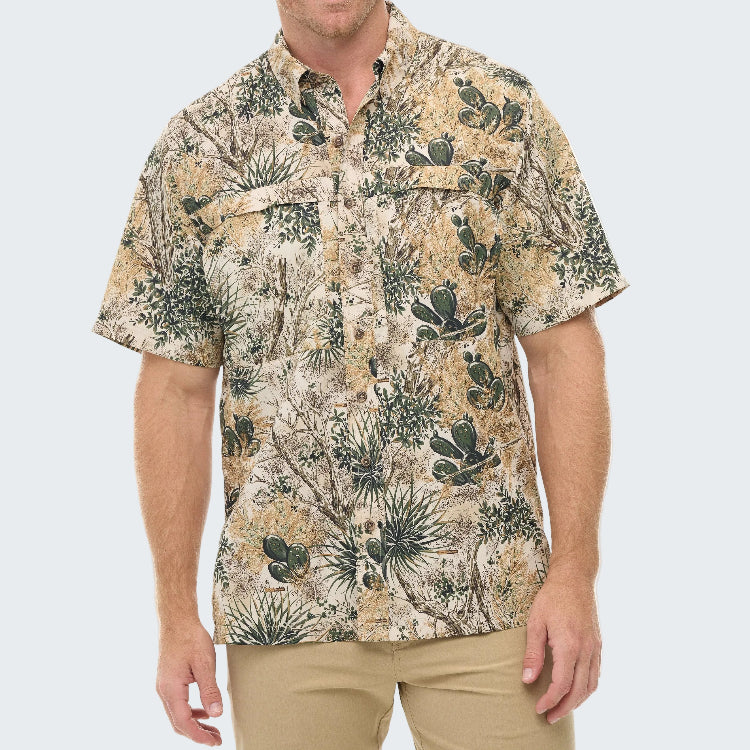 Man wearing a patterned shirt with cactus design on a white background