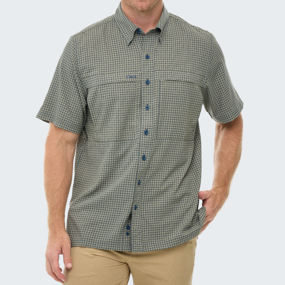 Man wearing a green checkered shirt with blue buttons on a white background