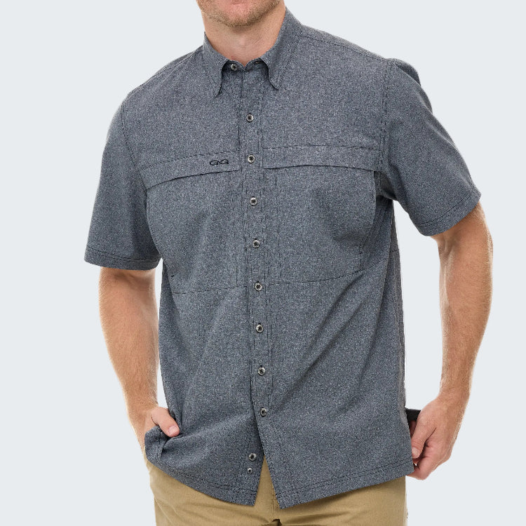 Man wearing a gray short-sleeve button-up shirt on a white background