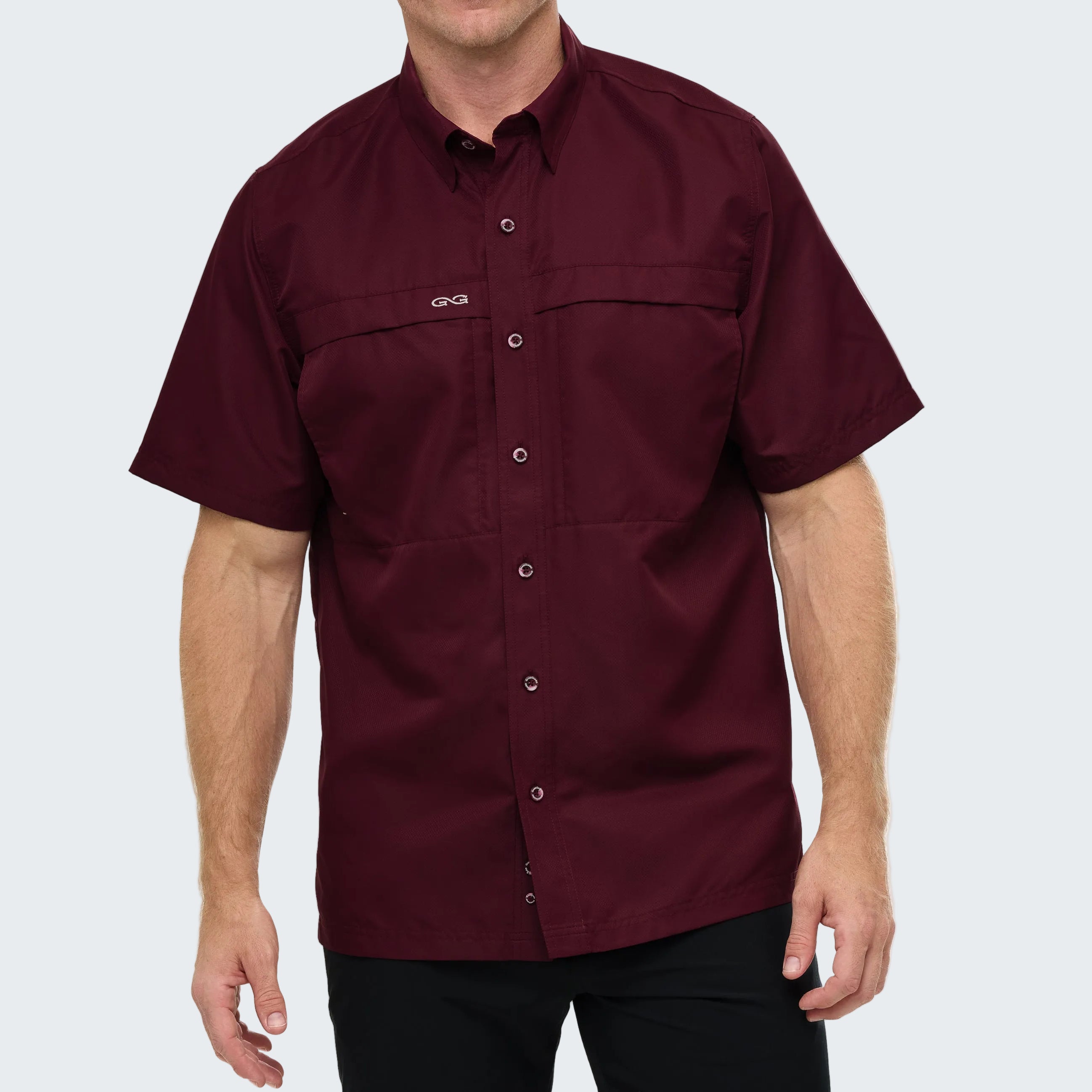 Maroon short-sleeve shirt with button details on a white background
