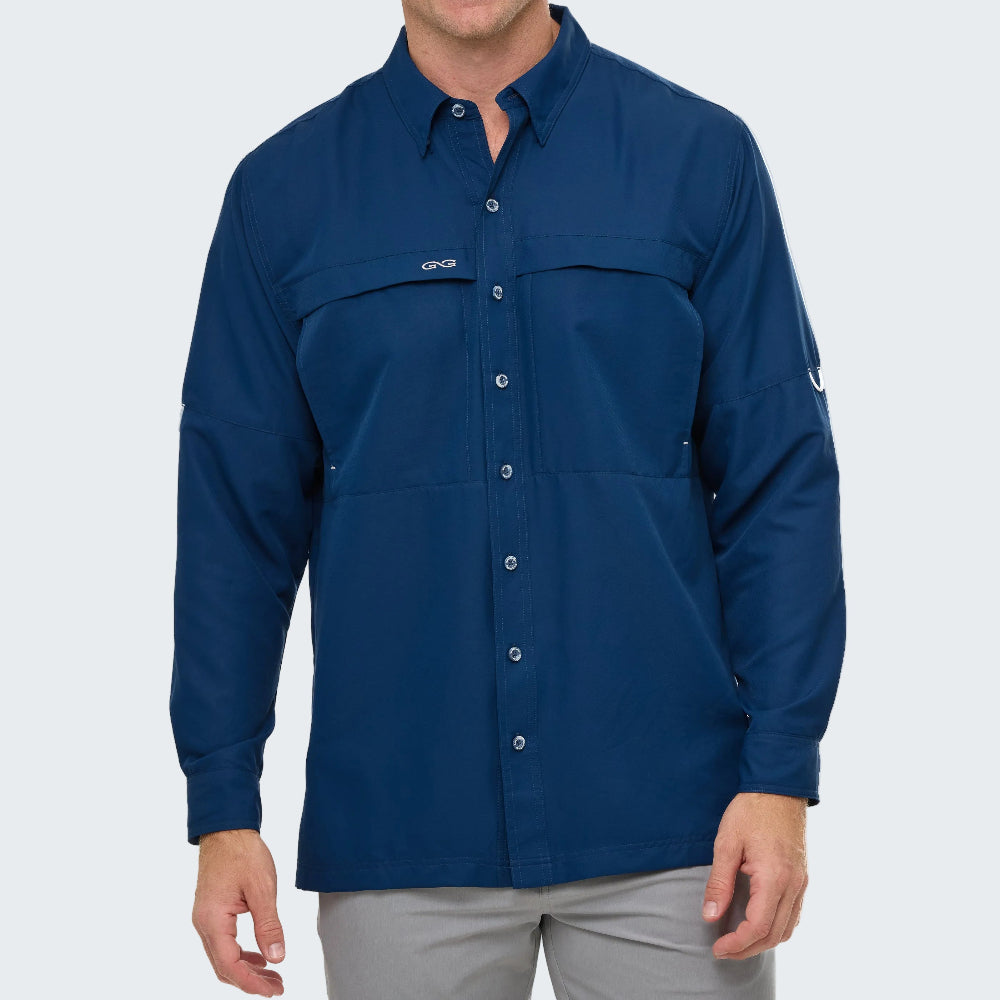 Man wearing a blue button-up shirt with a logo on a white background