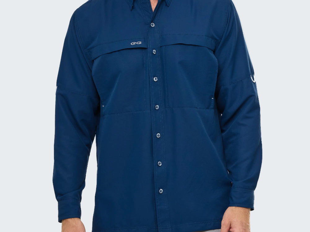 Man wearing a blue button-up shirt with a logo on a white background