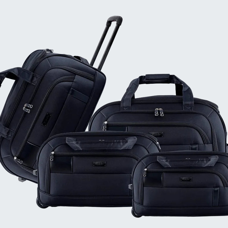 Set of black suitcases including a backpack, duffel bag, and two rolling suitcases on a white background