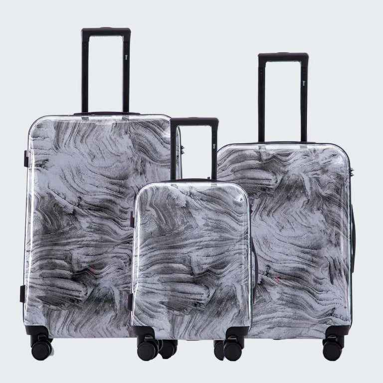 Set of three gray marbled suitcases with wheels on a white background