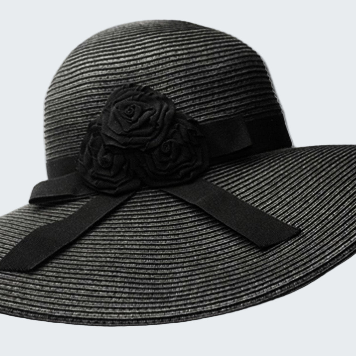 Black straw hat with a flower and bow on a white background