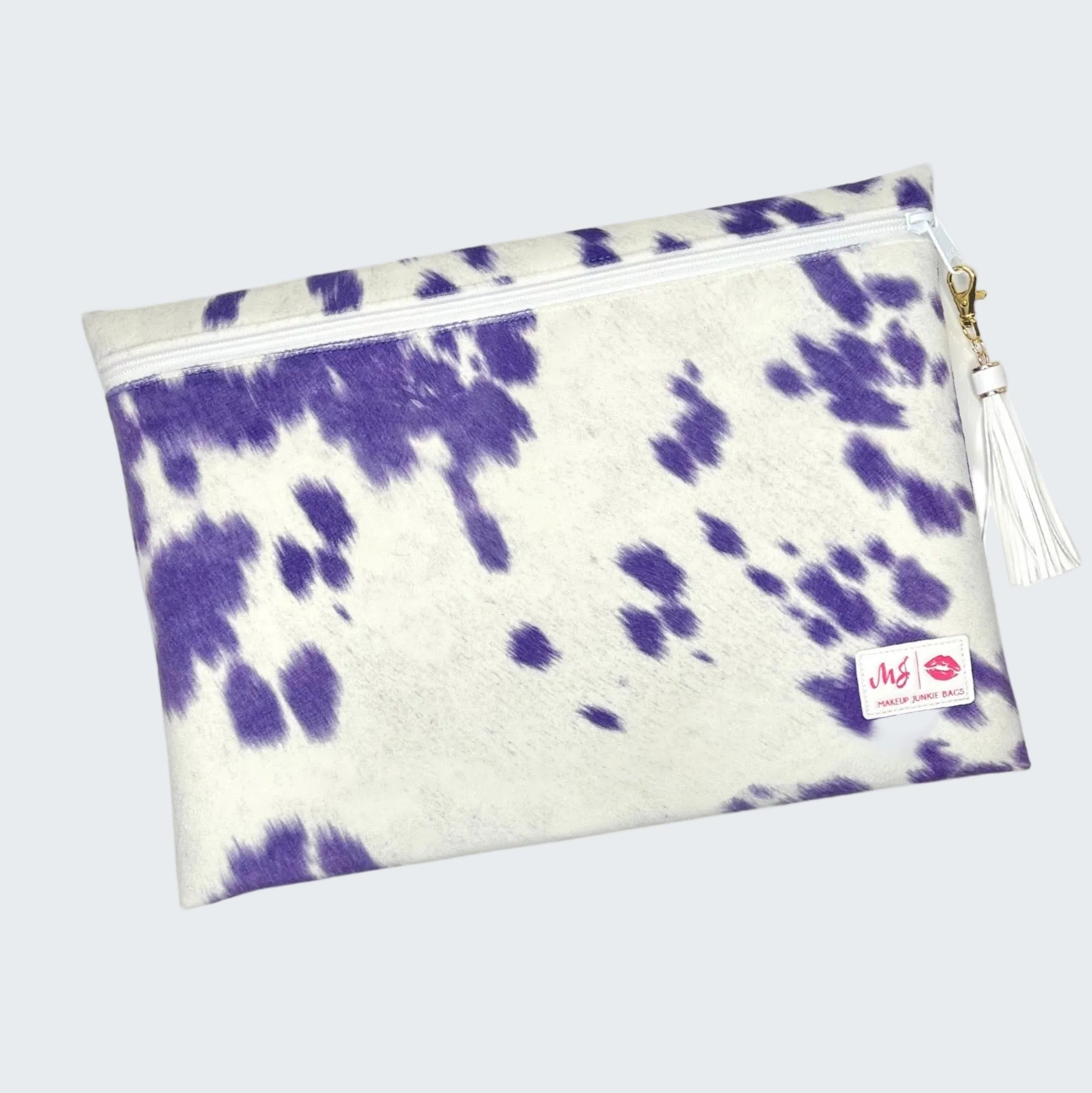 Purple and white tie-dye pouch with a tassel on a white background
