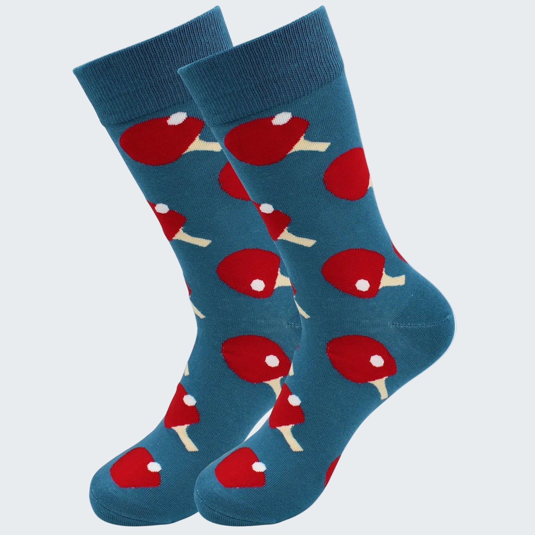 Blue socks with red and white ping pong ball pattern on a white background