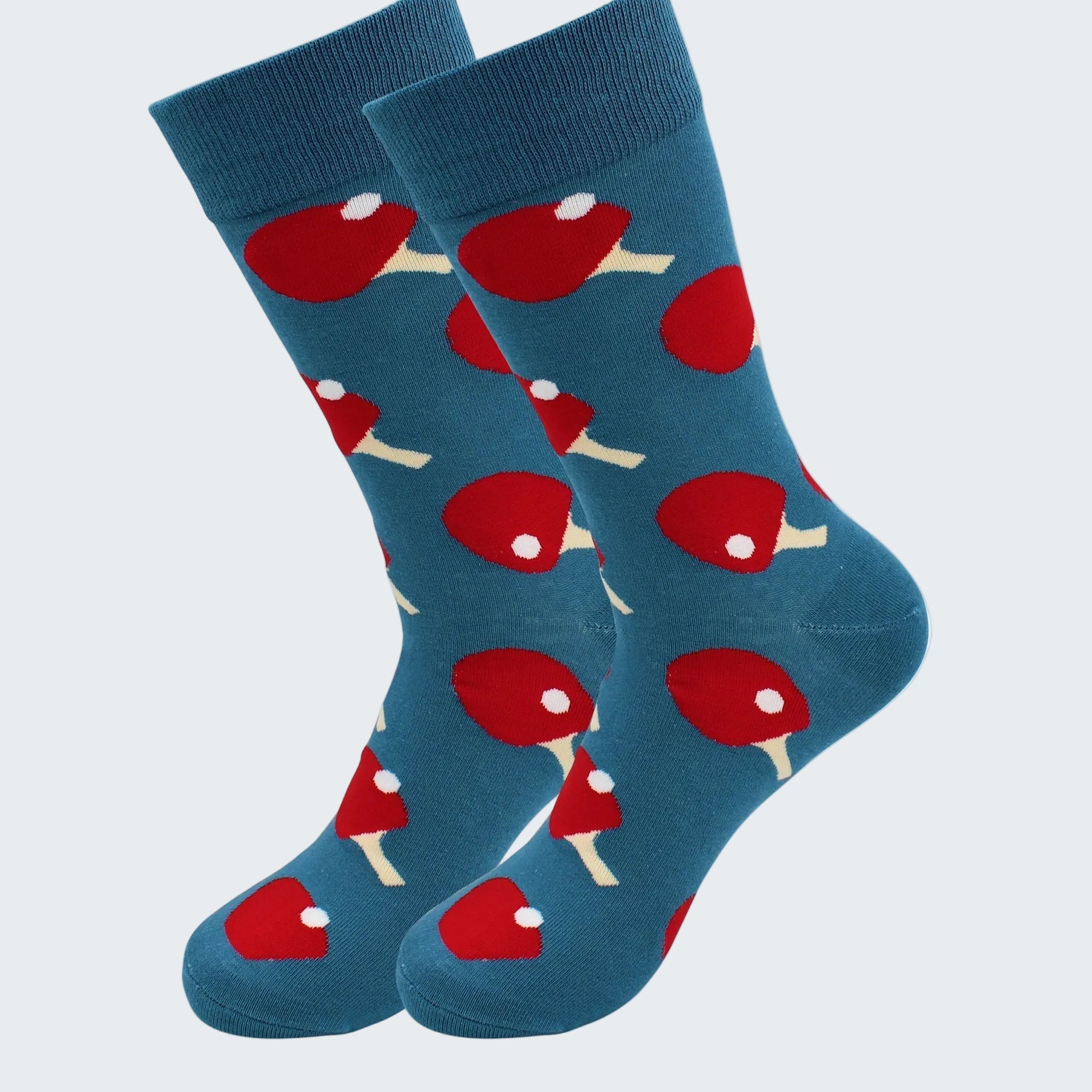 Blue socks with red and white ping pong ball pattern on a white background