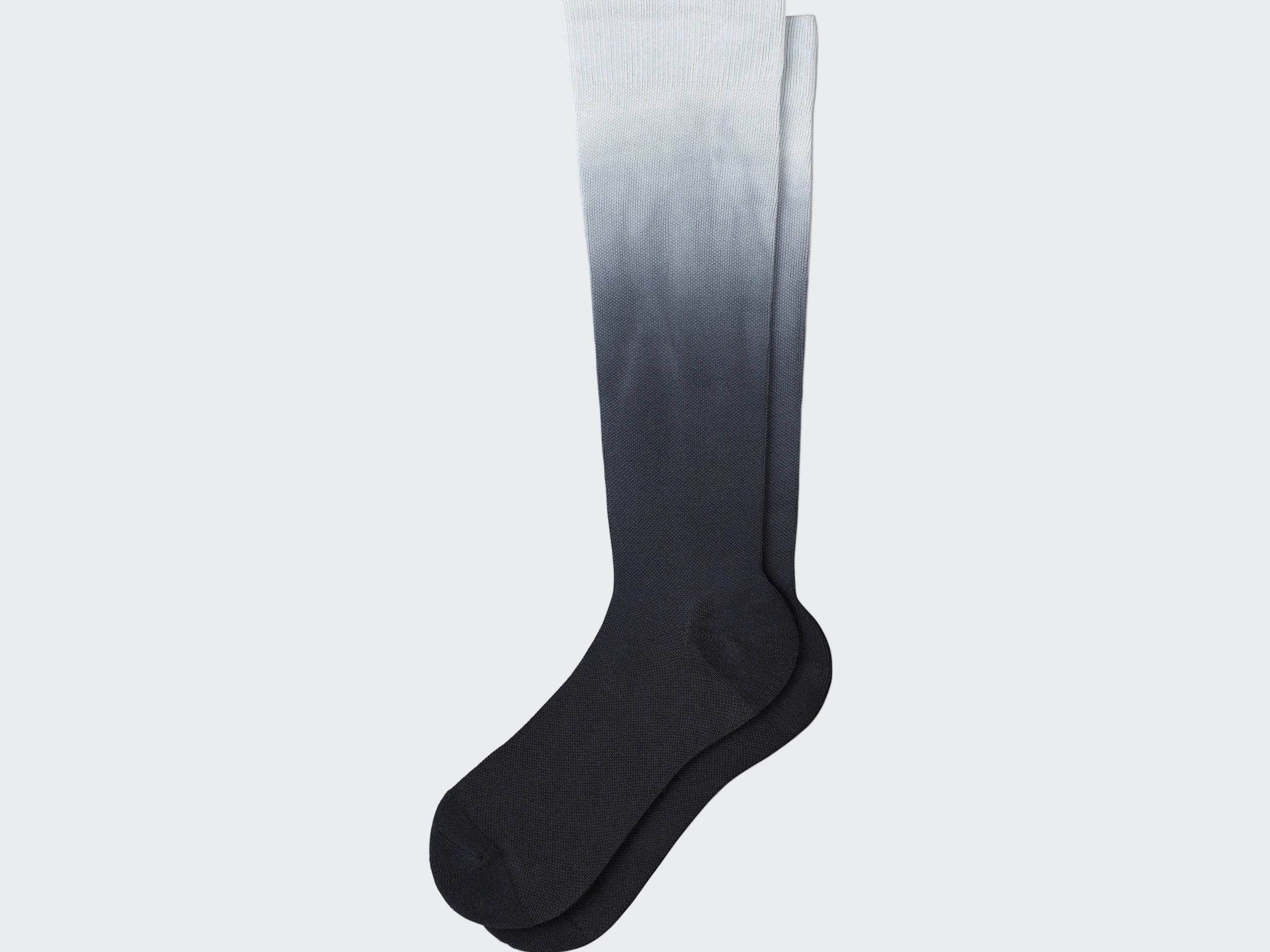 Knee-high sock with gradient color from white to black on a white background