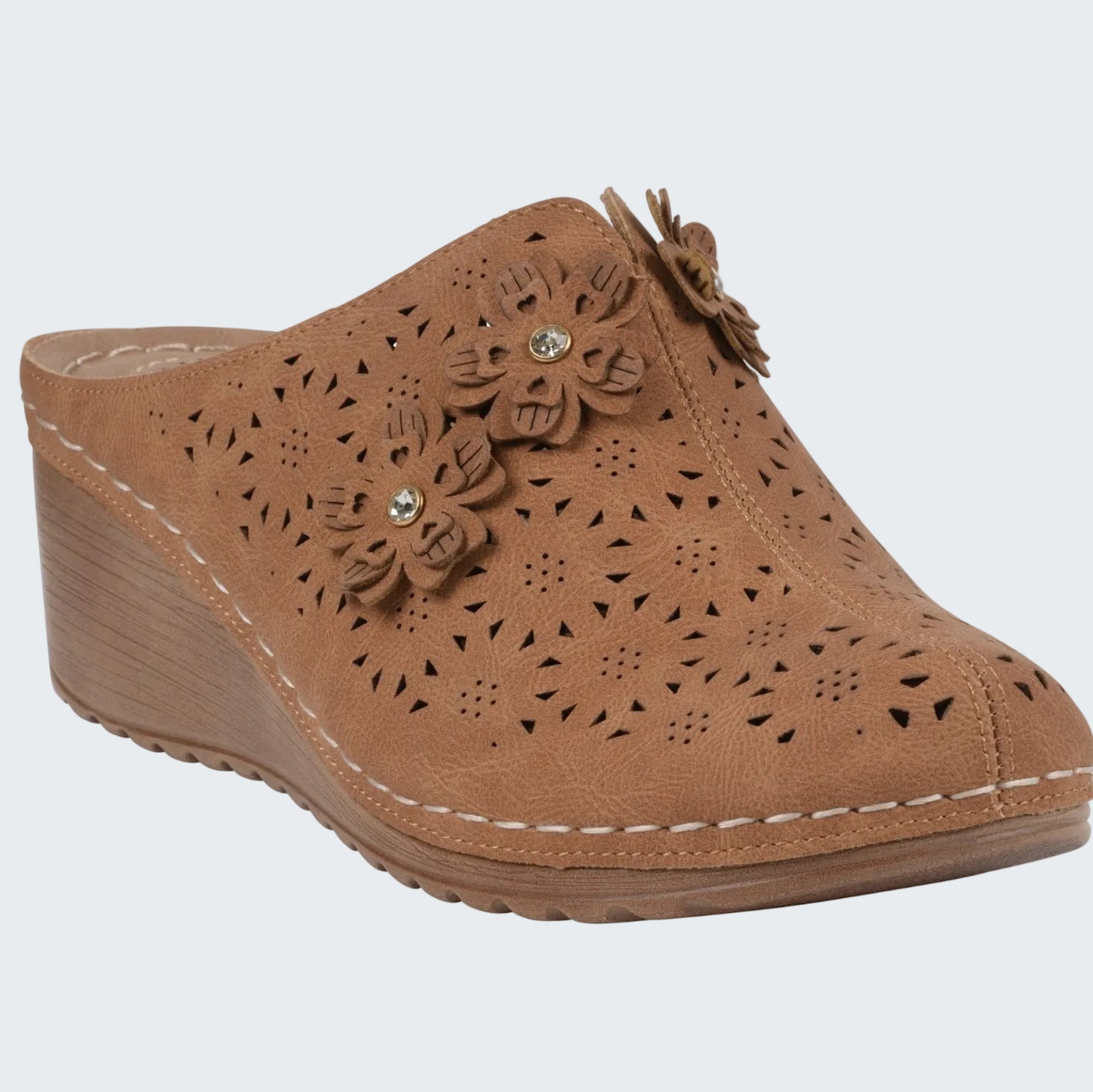 Brown wedge clog shoe with floral designs on a white background