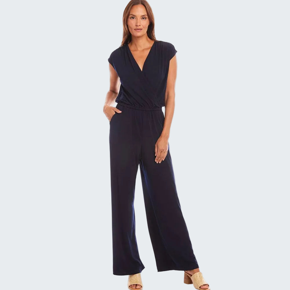 Woman wearing a navy blue jumpsuit on a white background