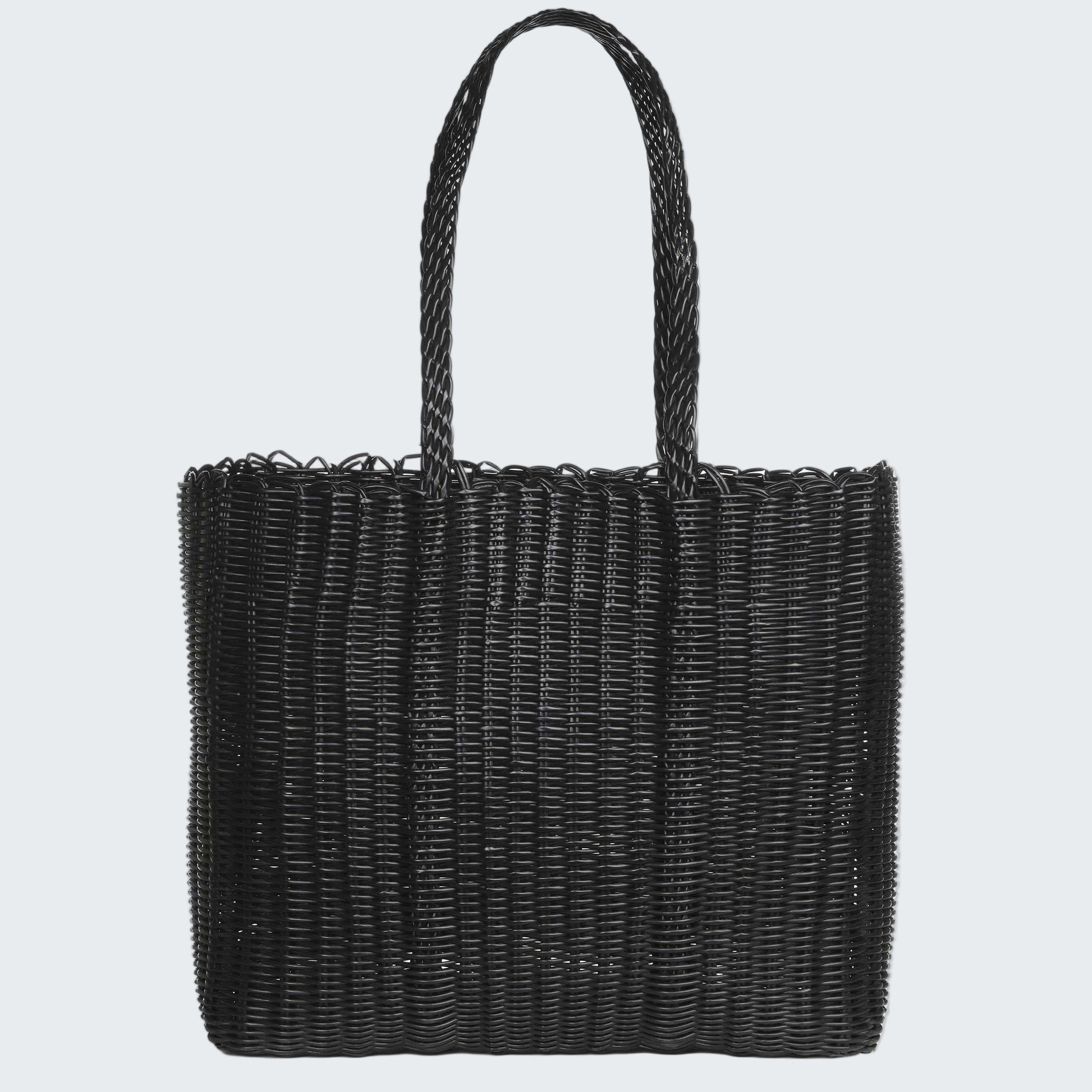 Black woven handbag on a white background