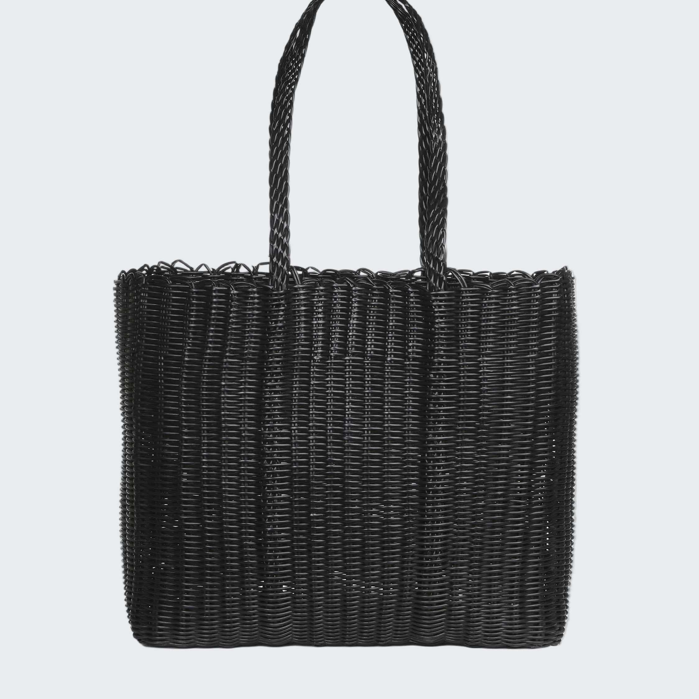Black woven handbag on a white background