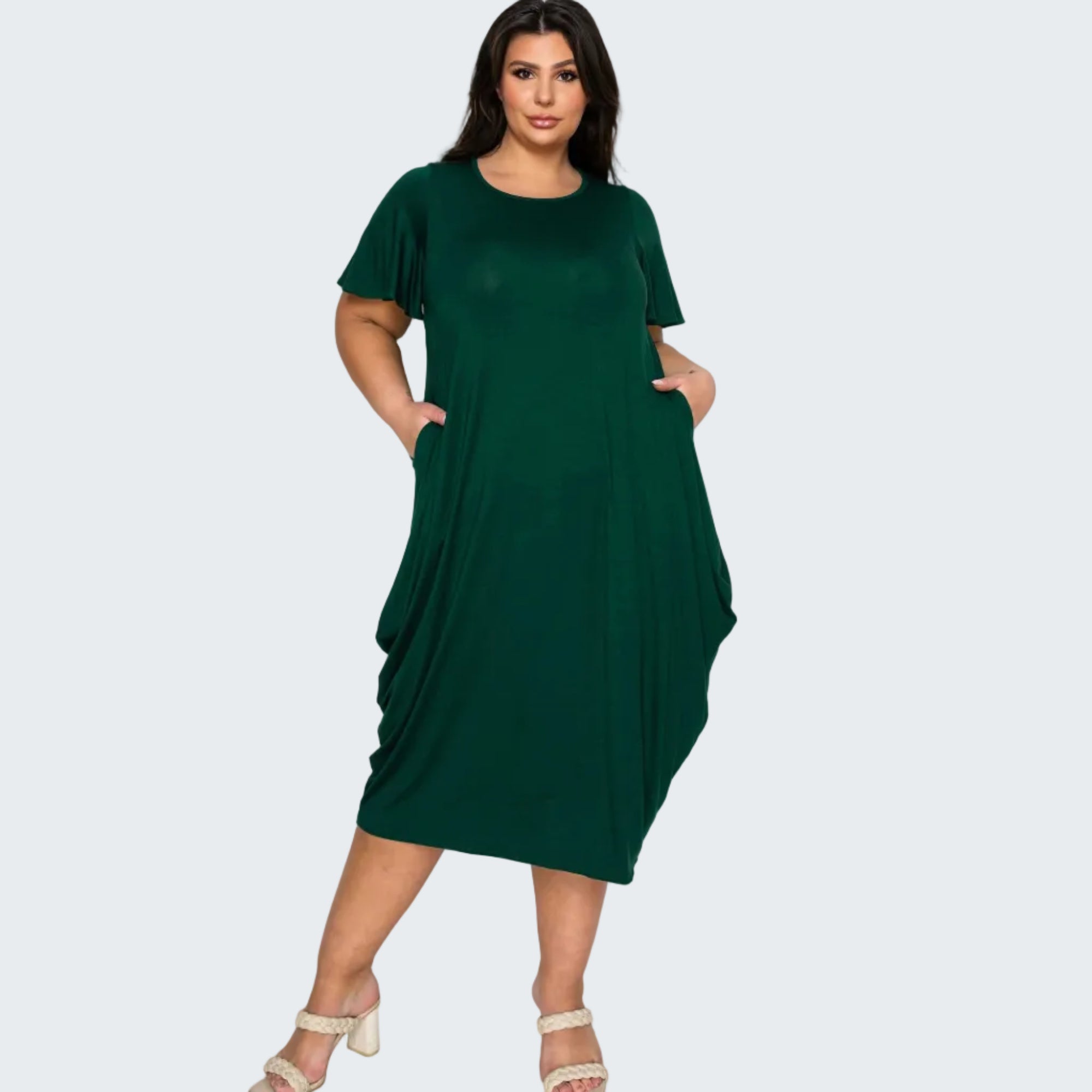 Woman wearing a green dress on a white background