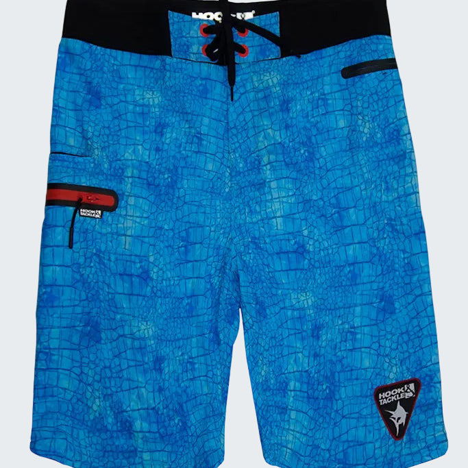 Blue patterned board shorts with a brand logo on a white background