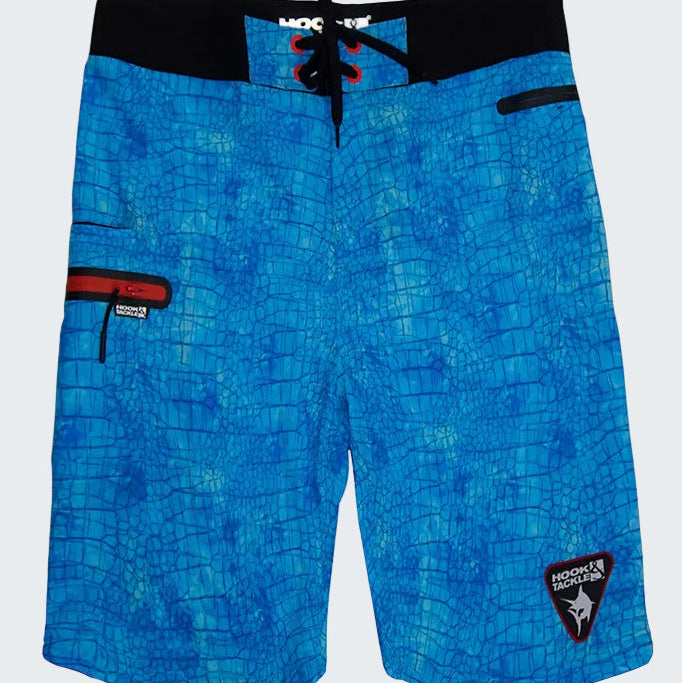 Blue patterned board shorts with a brand logo on a white background