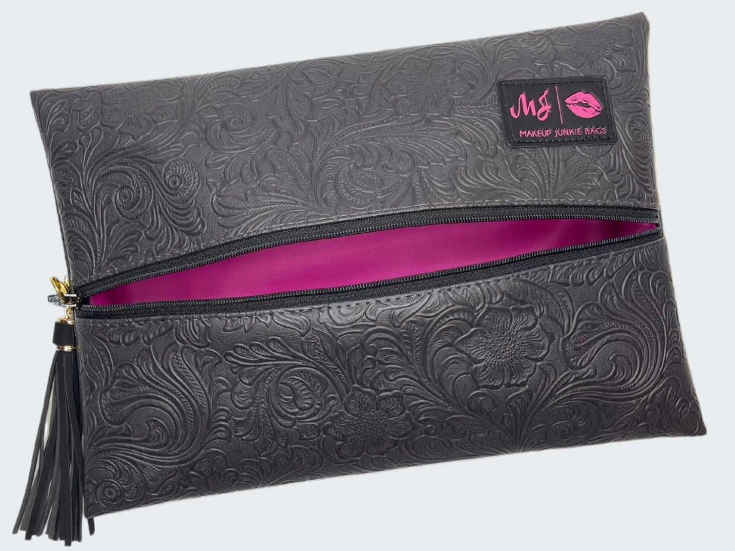 Black embossed clutch bag with a pink interior and visible brand logo on a white background