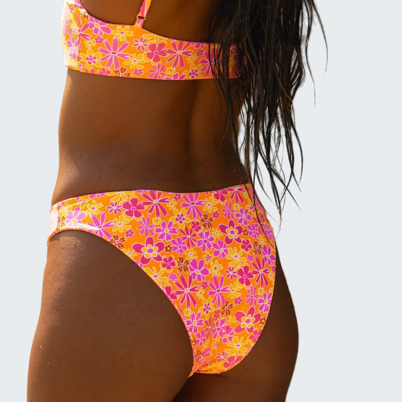 Person wearing a colorful floral bikini against a natural background