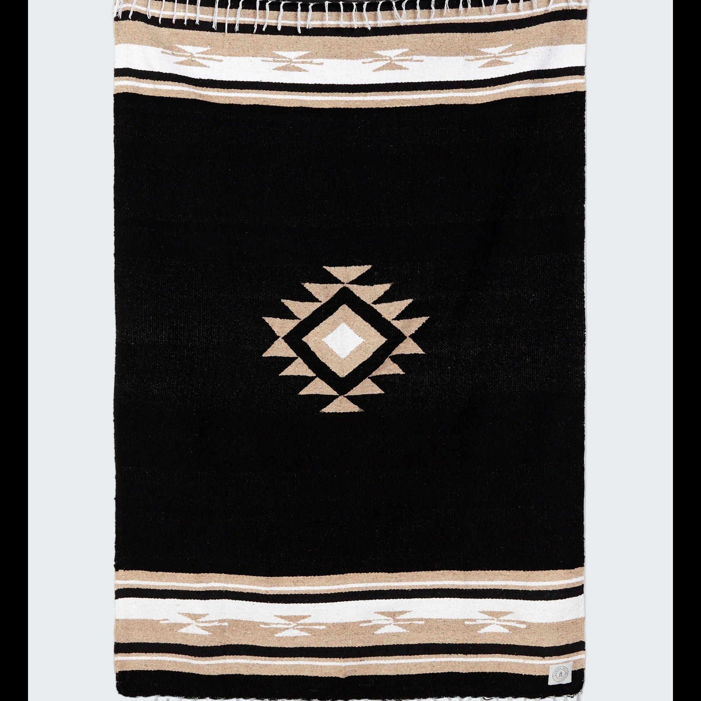 Black blanket with geometric pattern and striped border on a white background