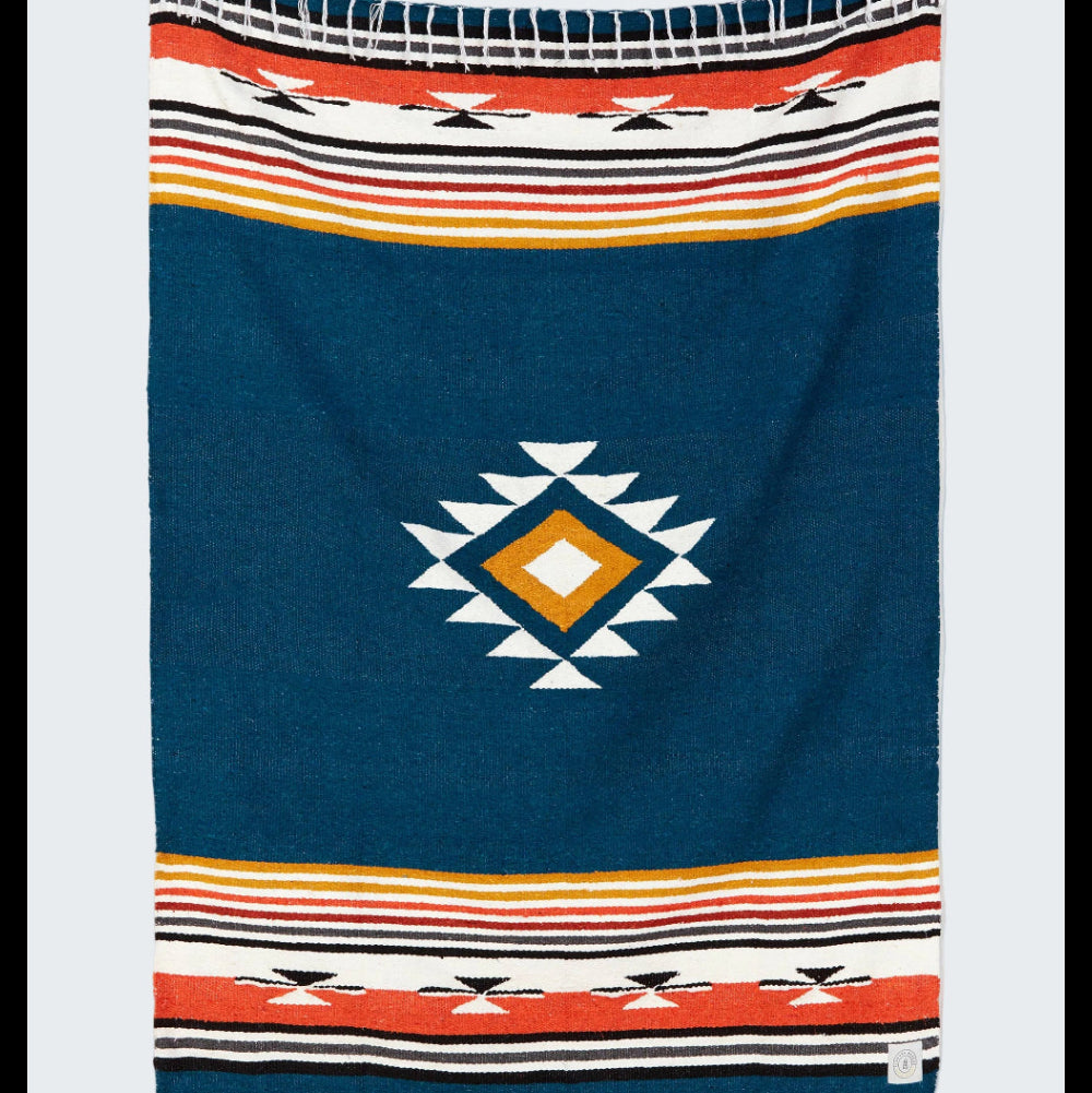 Navy blue blanket with geometric pattern and colorful stripes on a white background
