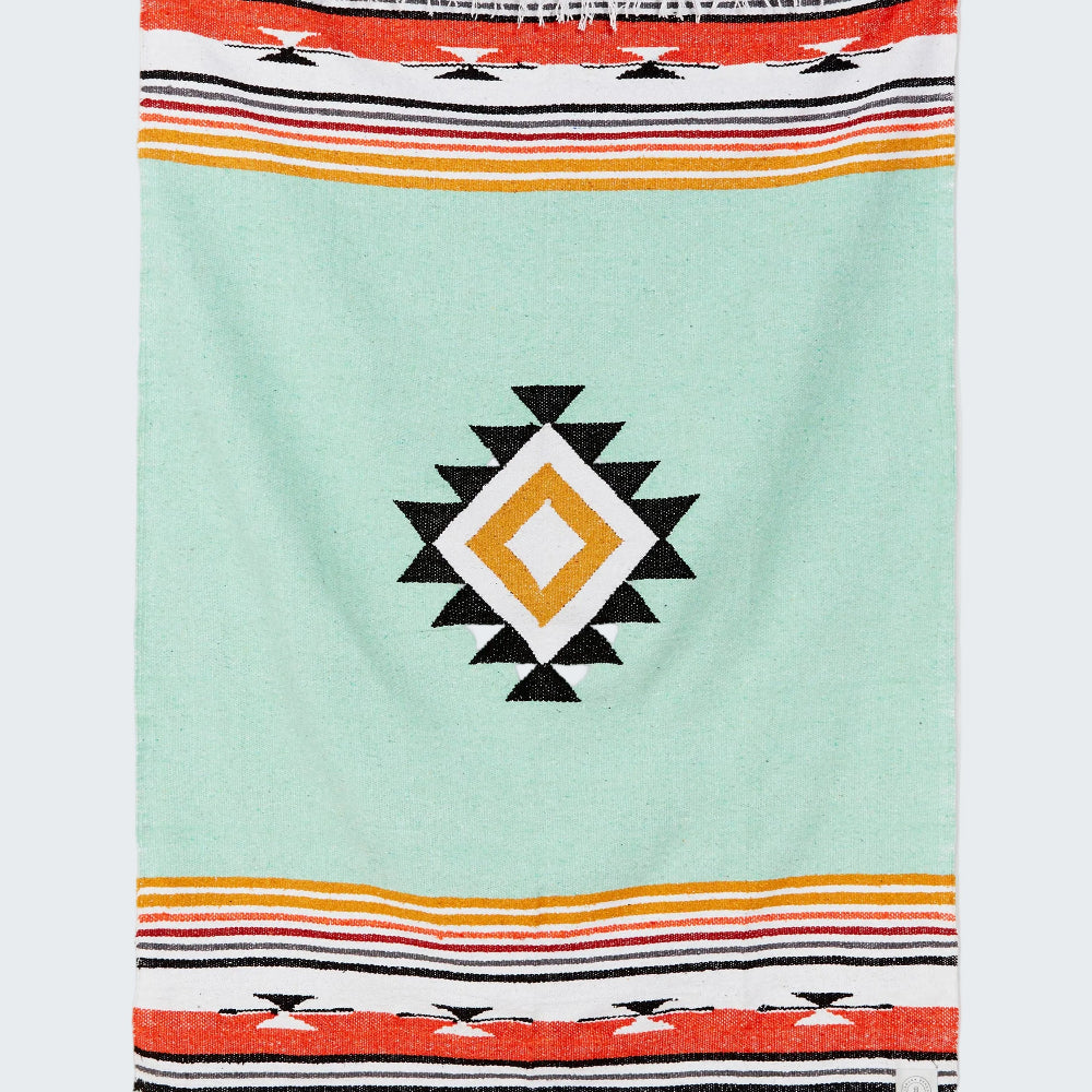 Colorful towel with geometric pattern on a light blue background