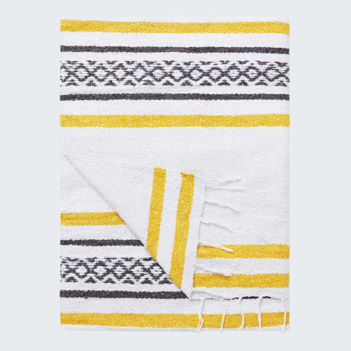 Folded blanket with yellow and gray pattern on a white background