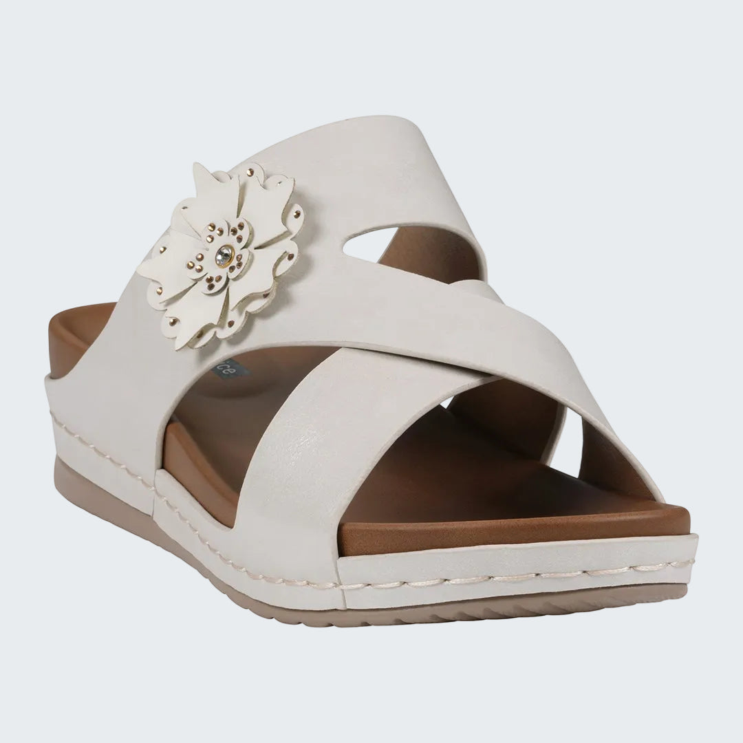 White sandal with a decorative flower on a white background