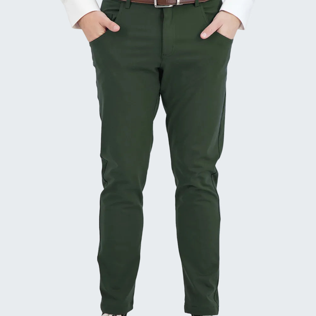 Person wearing green pants with a white shirt and black sneakers on a white background