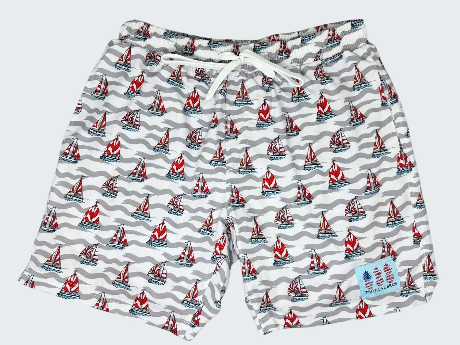Swim shorts with sailboat pattern on a white background, labeled '10 Year Anniversary 2026 Limited Edition'.