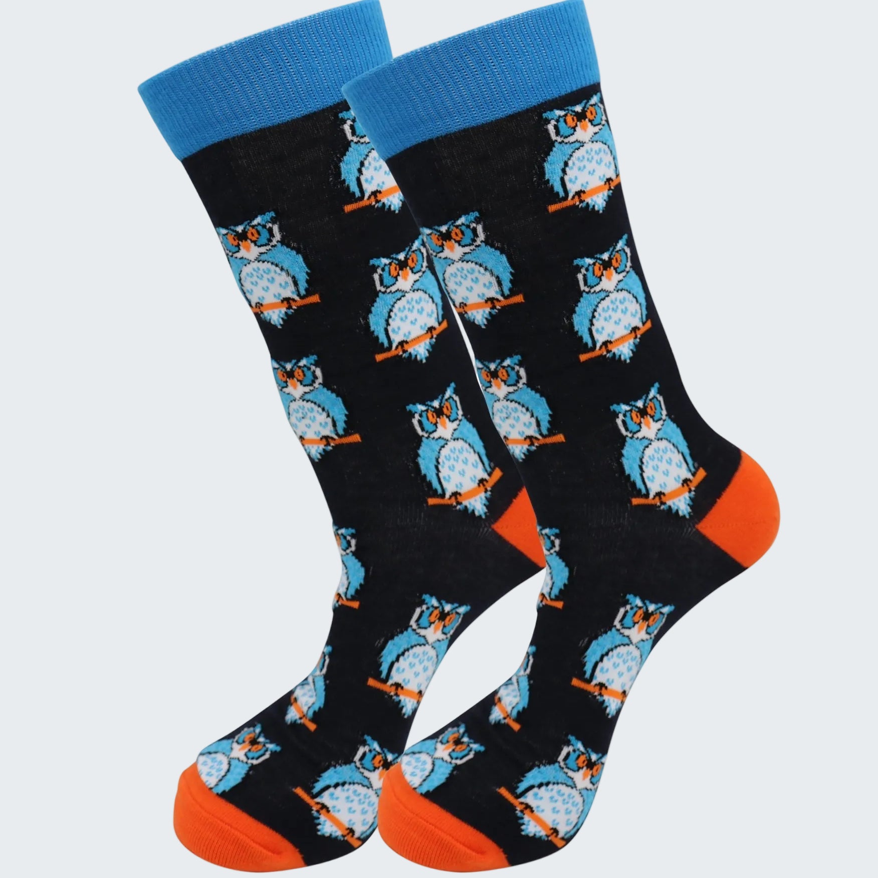 Pair of socks with owl pattern on a black background, blue top, and orange toes.