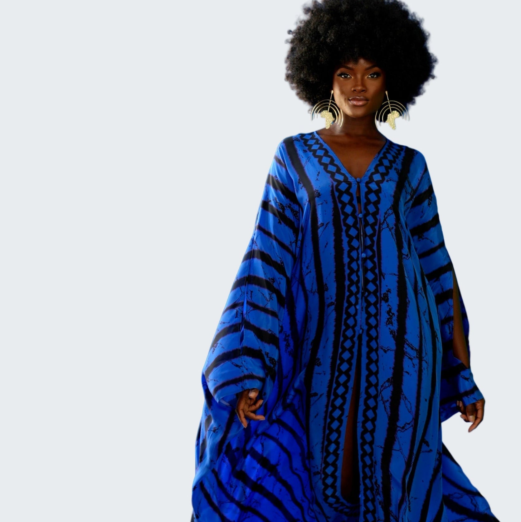 Woman wearing a blue patterned dress against a blue background