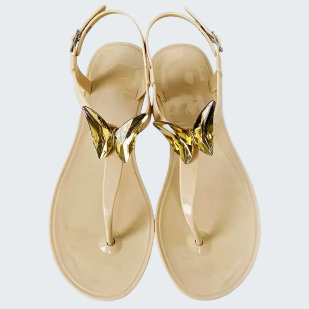 Gold sandals with a white background
