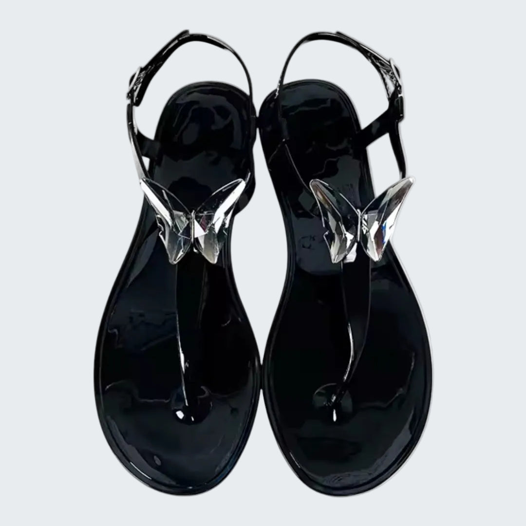Black sandals with clear straps on a white background