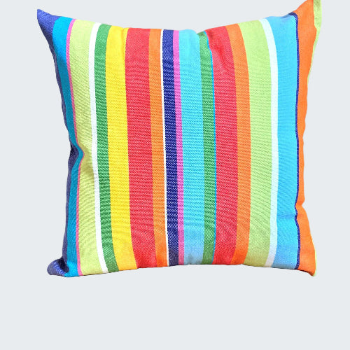 Colorful striped pillow on a wooden stool against a neutral wall