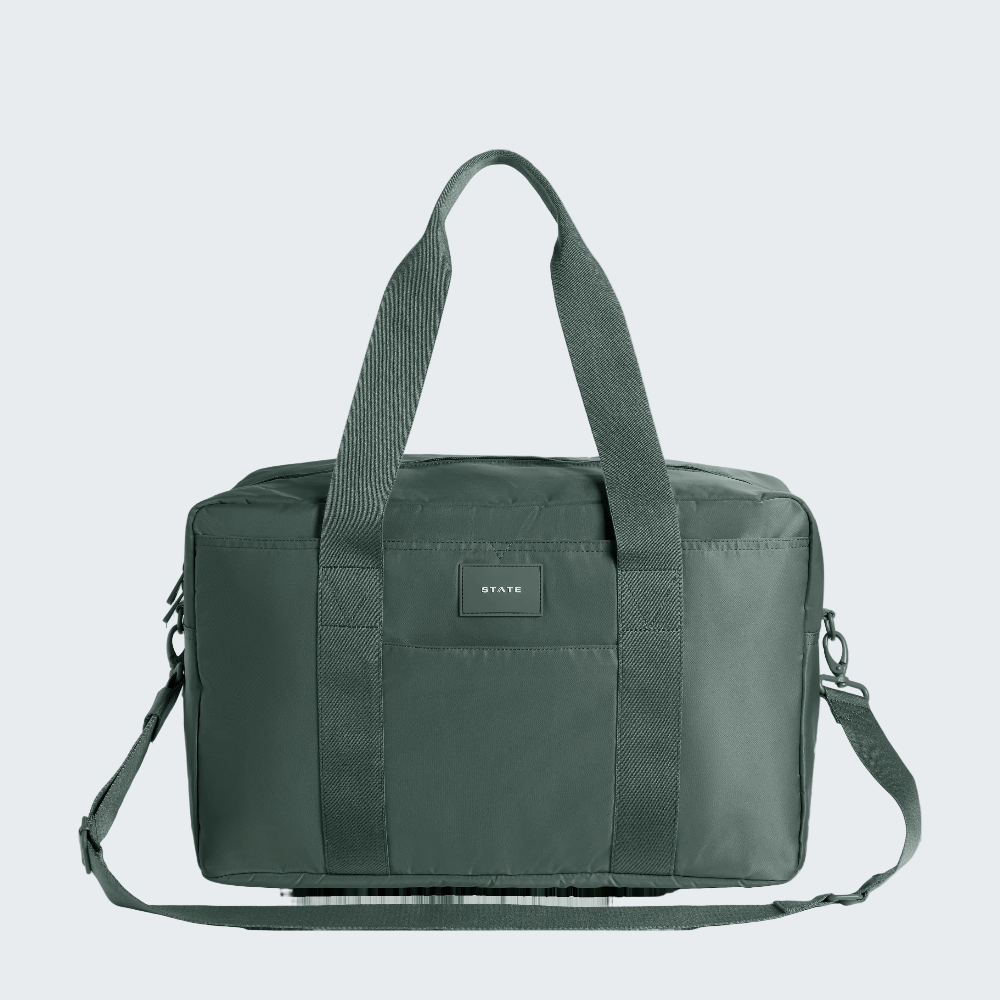 Green duffel bag with straps on a white background