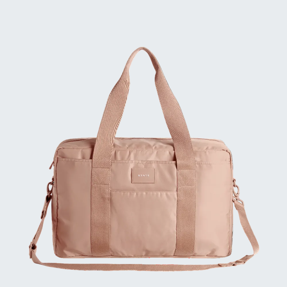 Beige duffel bag with shoulder straps on a white background