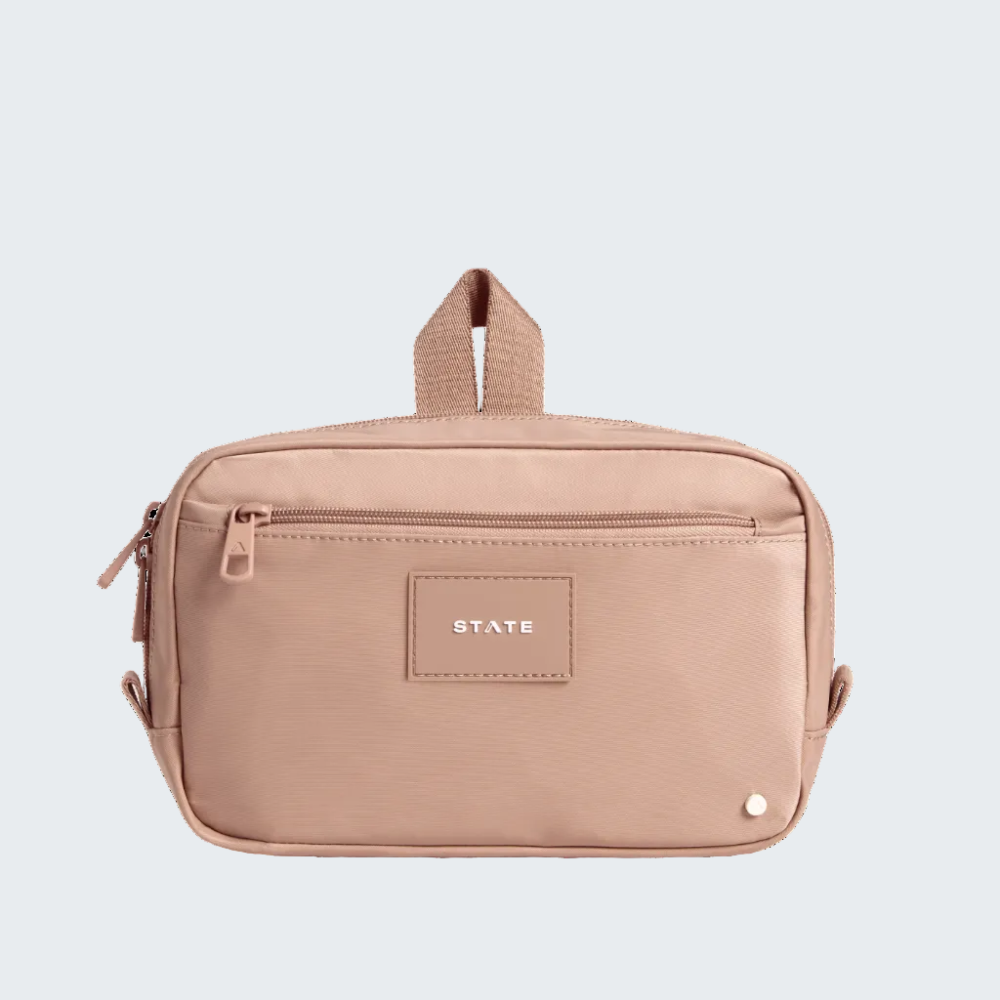 Beige toiletry bag with 'STATE' label on a white background