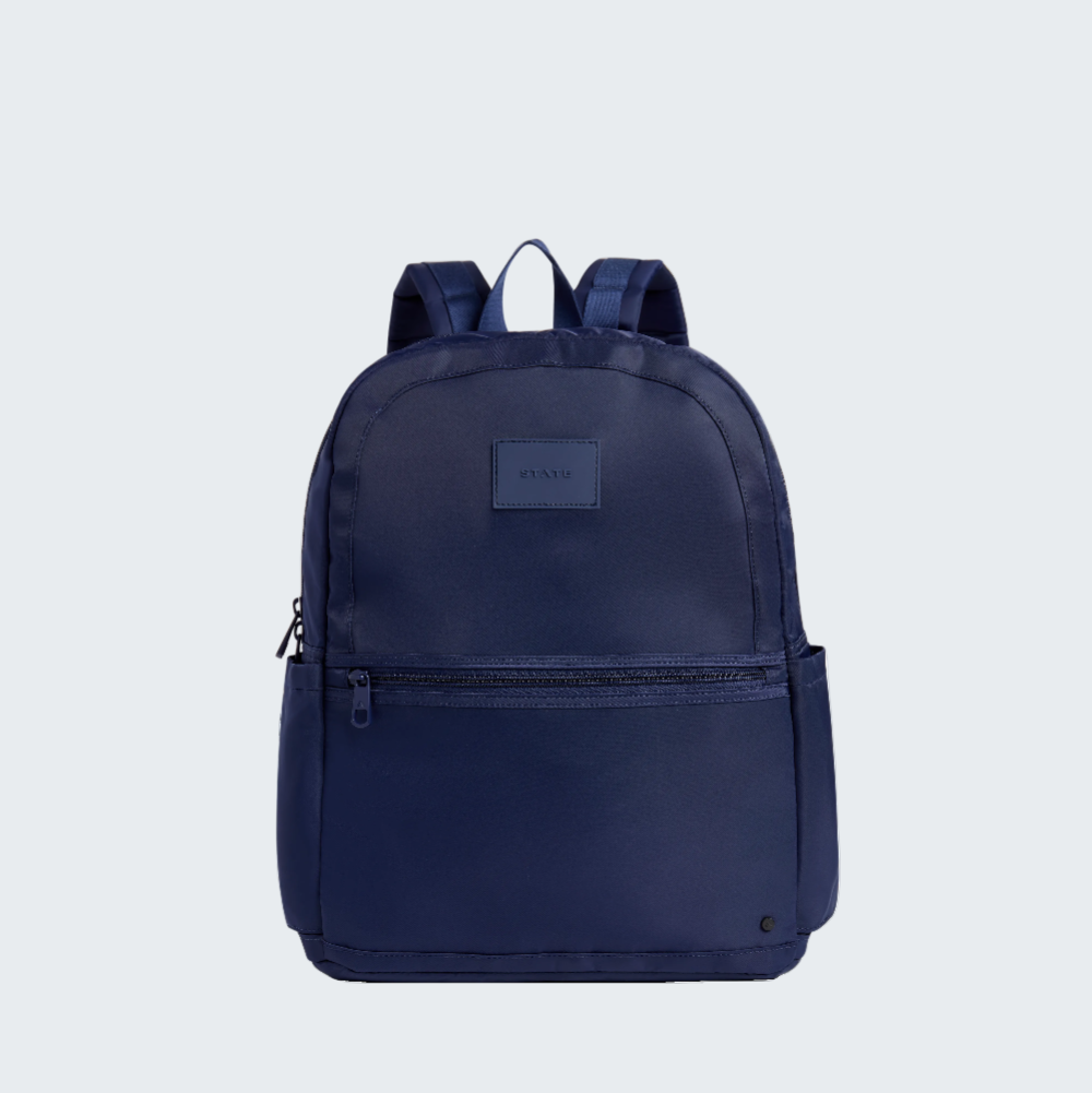 Navy blue backpack with a visible brand logo on a white background