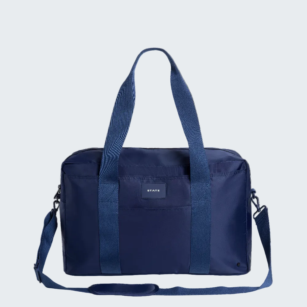 Navy blue duffel bag with shoulder strap on a white background