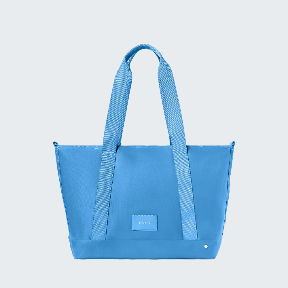 Blue tote bag with a visible brand logo on a white background