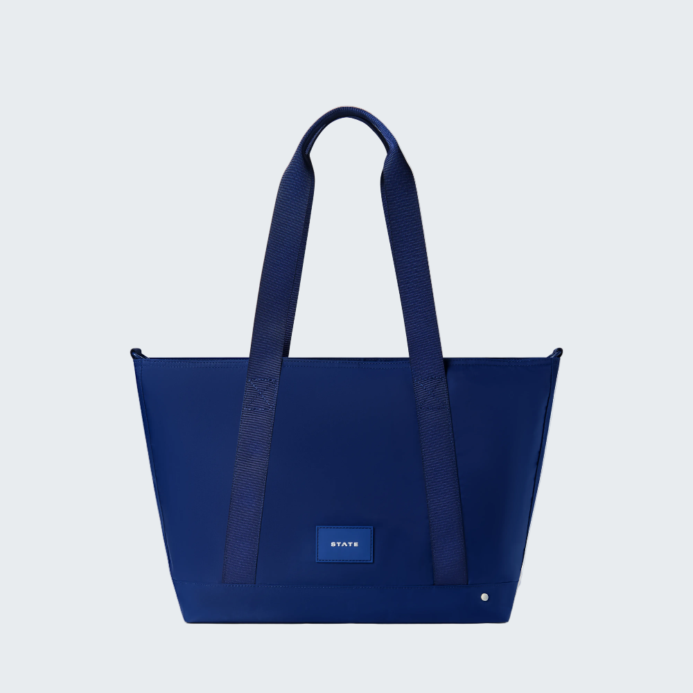 Blue tote bag with matching straps on a white background