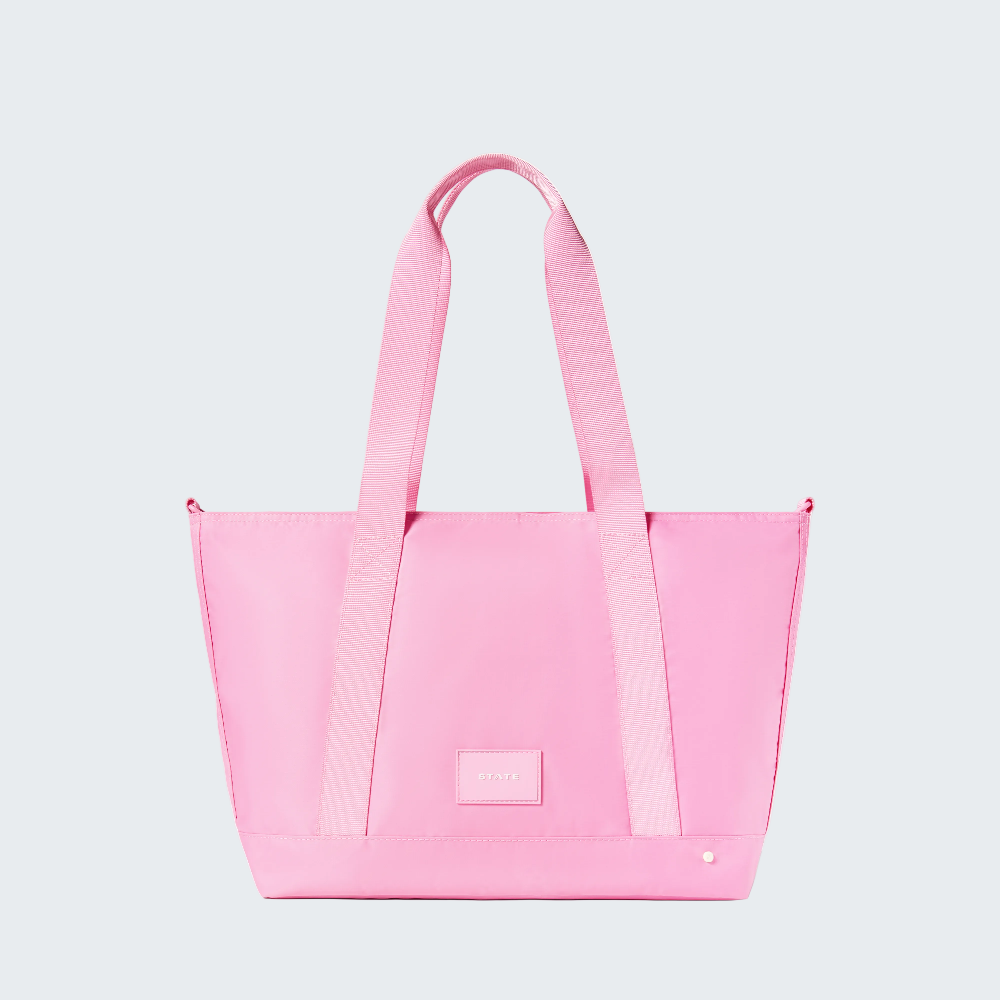 Pink tote bag with a visible brand logo on a white background