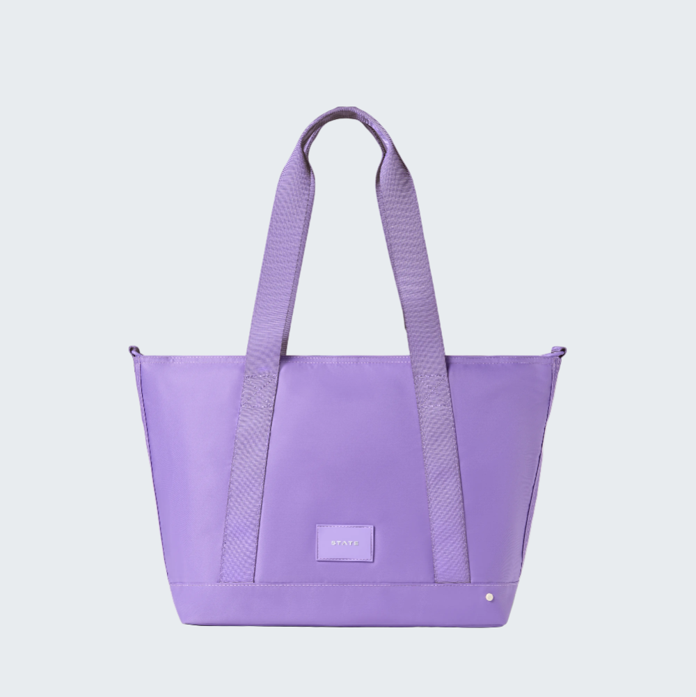 Purple tote bag with a visible brand logo on a white background