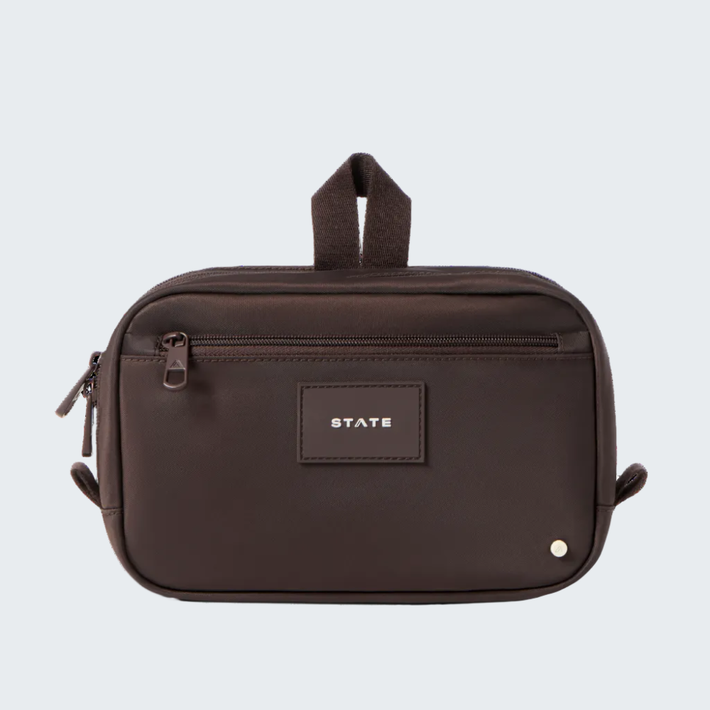 Brown toiletry bag with 'STATE' label on a white background