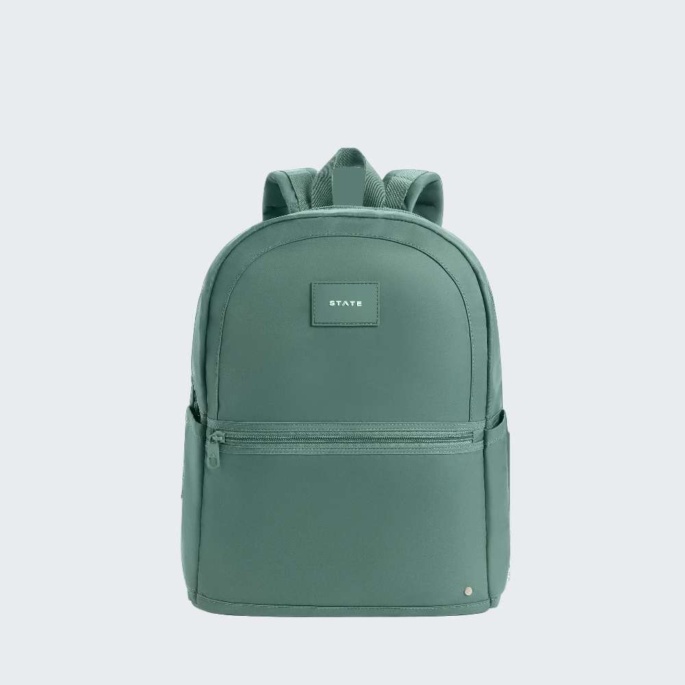 Green backpack with a visible brand label on a white background